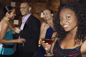 a woman wearing an attractive black dress at a party