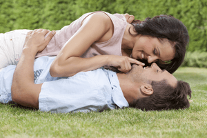 a young couple laying on the grass